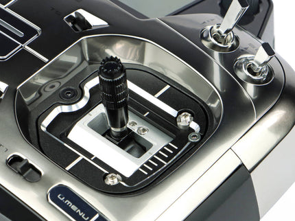 Close-up of a Futaba T26SZ Pro 26‑Channel Air Radio with detailed components on a white background