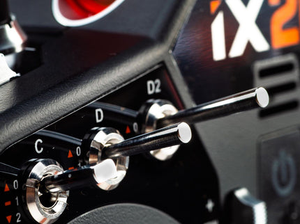 Close-up of control knobs on a device with 'ix2' branding.