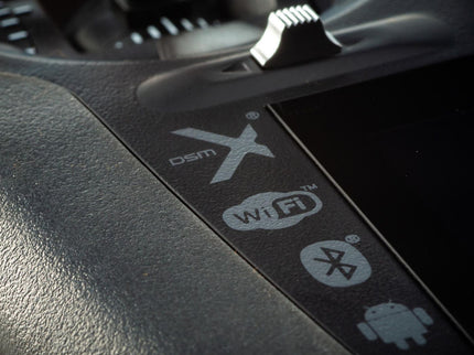 Car dashboard with DSMX, Wi-Fi, Bluetooth, and Android logos.