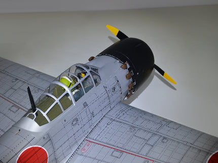 Phoenix Model ZERO A6M Model airplane on a grid surface with a plain background