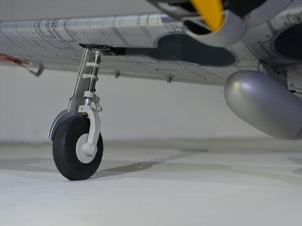 Phoenix Model ZERO A6M Close-up of an airplane wheel and part of its body on a white background