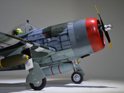 Phoenix Model P-47 Thunderbolt 79" ARF V2 with Electric Retracts Model airplane with a red engine and camouflage body on a gray background