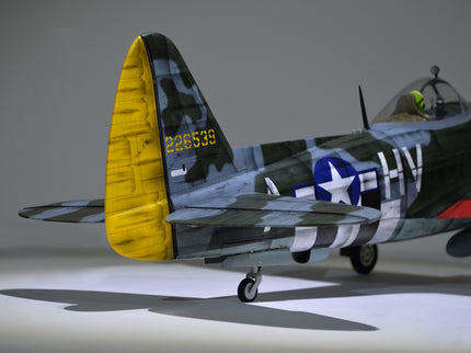 Phoenix Model P-47 Thunderbolt 79" ARF V2 with Electric Retracts Model airplane with a yellow tail fin on a gray background