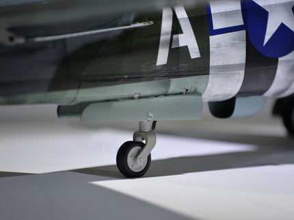 Phoenix Model P-47 Thunderbolt 79" ARF V2 with Electric Retracts Close-up of a model airplane with a visible wheel on a neutral background