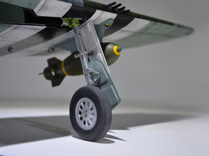 Phoenix Model P-47 Thunderbolt 79" ARF V2 with Electric Retracts Close-up of an airplane wheel and wing with a blurred background