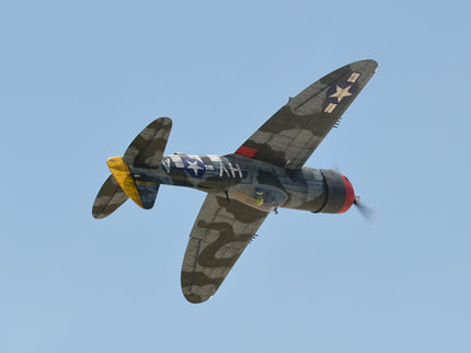 Phoenix Model P-47 Thunderbolt 79" ARF V2 with Electric Retracts Vintage military airplane flying against a clear blue sky
