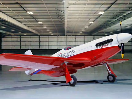 Phoenix Model STREGA 56'' W/Electric Retract Red and white airplane in a large hangar
