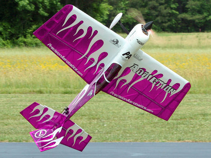 Model airplane with purple and white design on a grassy field