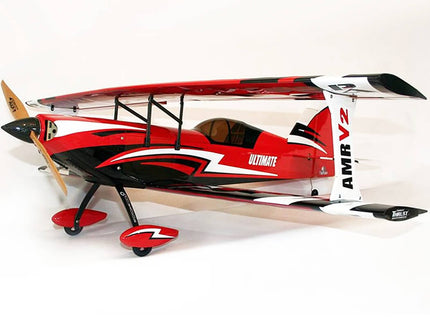 Red and white model airplane with propeller on a white background