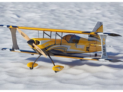 Yellow and gray biplane model on a snowy surface
