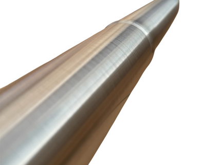 A close-up of a metallic cylindrical rod or shaft with a brushed silver finish and a warm gold-toned section, shown against a plain white background.