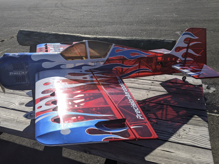 Model airplane with flame design on a wooden surface
