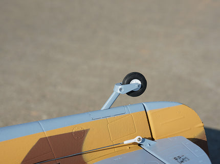 Close-up of a model airplane's landing gear on a blurred background