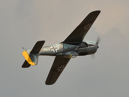 Phoenix Model FOCKE WULF WW2 Vintage airplane with a visible logo flying against a gray sky
