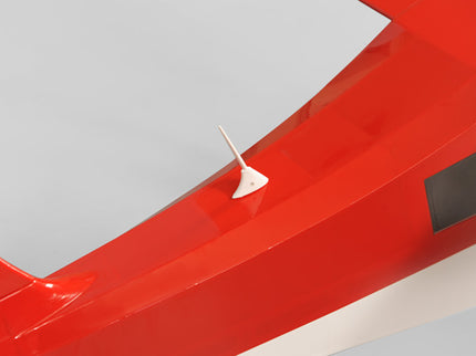 Close-up of a red Phoenix Model DECATHLON with a white plastic ariel on a gray background