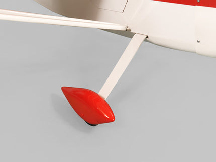 Close-up of a red Phoenix Model DECATHLON airplane on a gray background