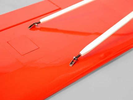 Close-up of a red Phoenix Model DECATHLON with white cables and connectors on a gray background