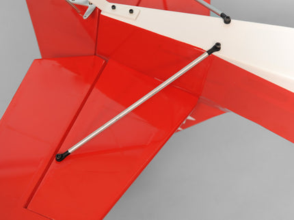 Close-up of a red and white Phoenix Model DECATHLON model airplane tail-plane on a gray background