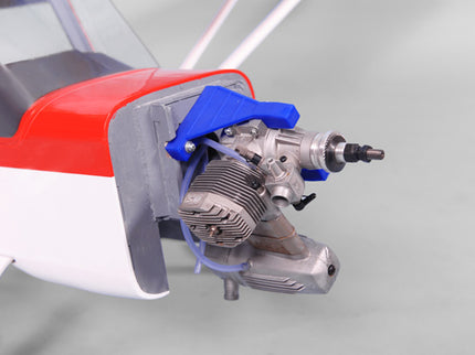 Close-up of a Phoenix Model DECATHLON model airplane engine with red and white body on a gray background