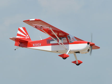 Red and white Phoenix Model DECATHLON airplane with a clear blue sky background