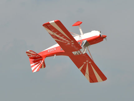 Red and white Phoenix Model DECATHLON airplane with 'N100K' on a clear sky background