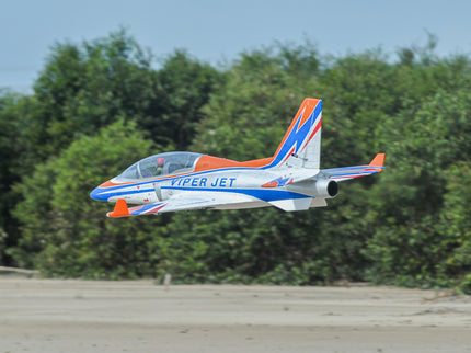 Phoenix Model VIPER JET 83'' With Electric Retract ARF V2 Model airplane labeled 'Viper Jet' flying over a forested area