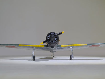 Phoenix Model ZERO A6M 55'' W/Electric Retract Model airplane with yellow accents on a plain background