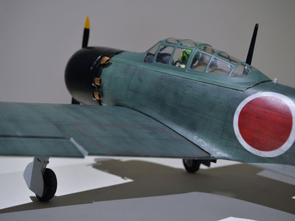 Phoenix Model ZERO A6M 55'' W/Electric Retract Model of a World War II era fighter plane with a red circle emblem on a gray background