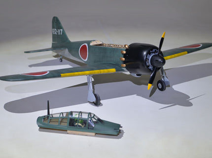 Phoenix Model ZERO A6M 55'' W/Electric Retract Model of a vintage military aircraft with a smaller vehicle on a gray background