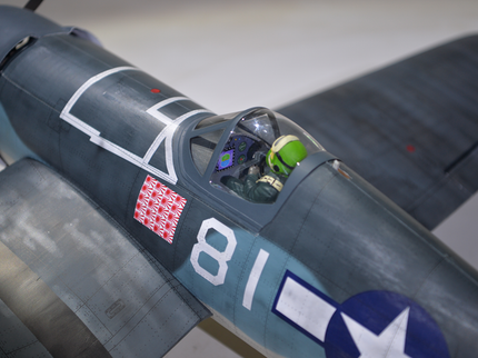 Phoenix Model F4U Corsair 59'' W/Electric Retract Close-up of a fighter jet with a pilot inside, featuring a visible logo on the side.