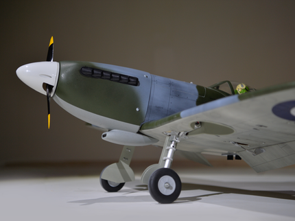 Phoenix Model Spitfire 55" W/Electric Retract Model of a vintage airplane with a propeller on a plain background