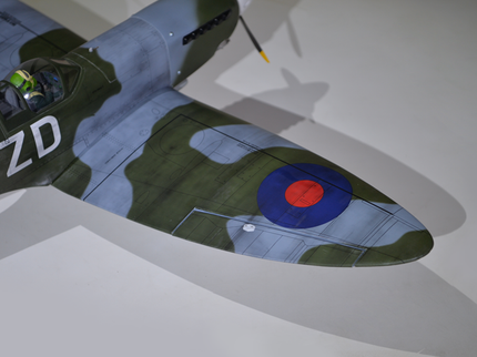 Phoenix Model Spitfire 55" W/Electric Retract Model airplane with camouflage paint job and visible branding on a white background