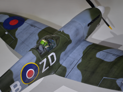Phoenix Model Spitfire 55" W/Electric Retract Model of a vintage fighter plane with camouflage pattern and visible branding on a white background