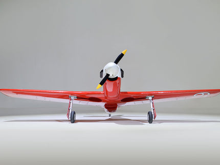 Phoenix Model STREGA 56'' W/Electric Retract Red model airplane with a propeller on a gray background