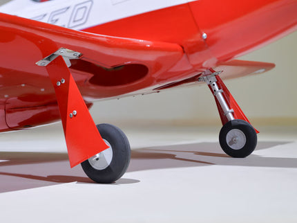 Phoenix Model STREGA 56'' W/Electric Retract Close-up of a red model airplane on a white surface
