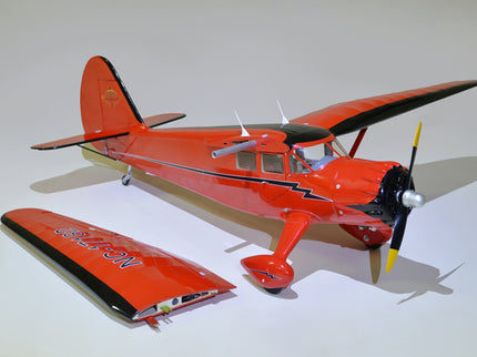 Model of a red Phoenix Model STINSON RELIANT 68" ARF airplane on a white background