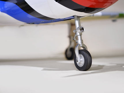 Phoenix Model TUCANO TURBOPROP 103" Close-up of a model airplane's landing gear on a white surface