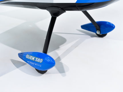 Phoenix Model SLICK 580 67" ARF V2 (20-26cc) Close-up of a blue and black outboard motor with 'Slick 580' branding on a white background