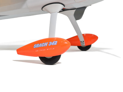 Close-up of an airplane with orange wheel pants labeled 'SBACH 342' on a white background