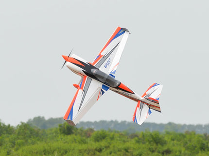 Phoenix Model SBACH 342 74'' ARF V2 Model airplane flying against a clear sky with trees in the background