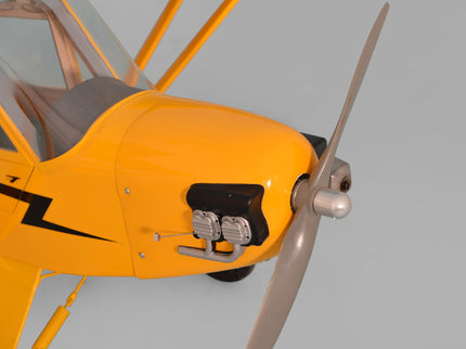 Close-up of a yellowPhoenix Model PIPER J3 CUB   airplane with a propeller on a gray background