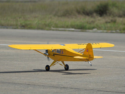 Yellow Phoenix Model PIPER J3 CUB  airplane on a runway with grass in the background