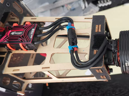 Close-up of a mechanical device with wiring and components on a reflective surface