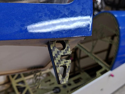Close-up of a blue and carbon fiber object with a blurred background