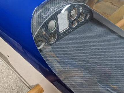 Close-up of a blue motorcycle with a transparent cover over the windshield.